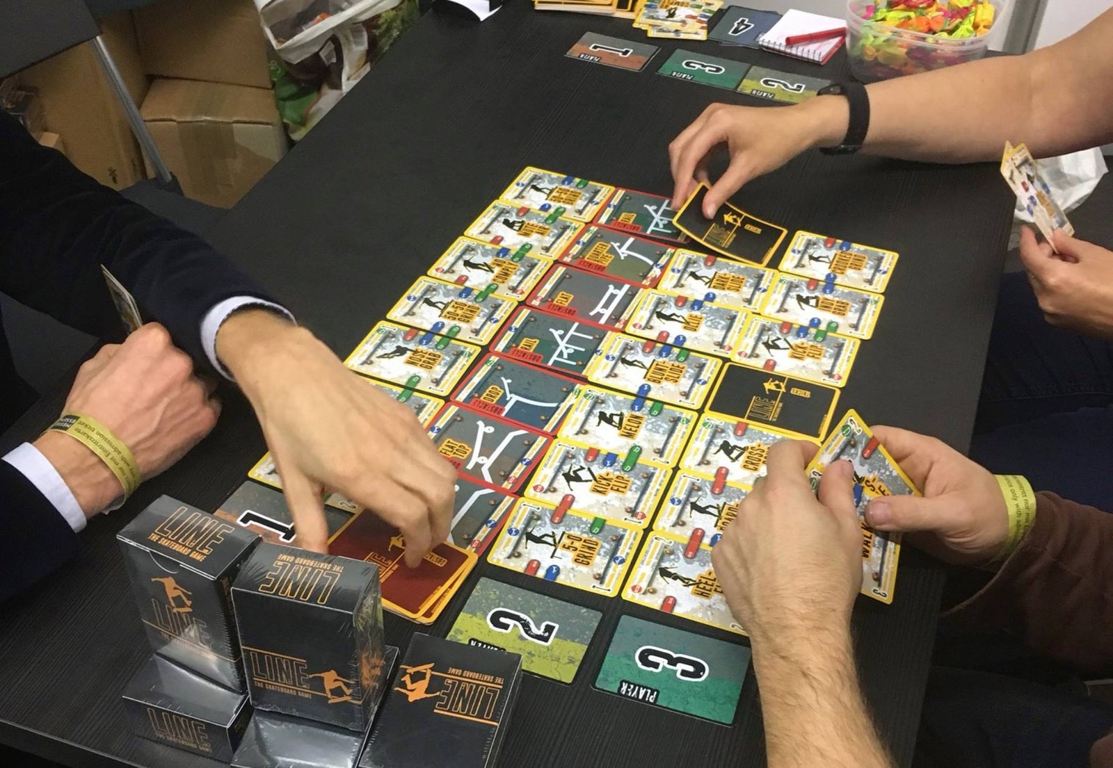 Board game being actively playtested around a table