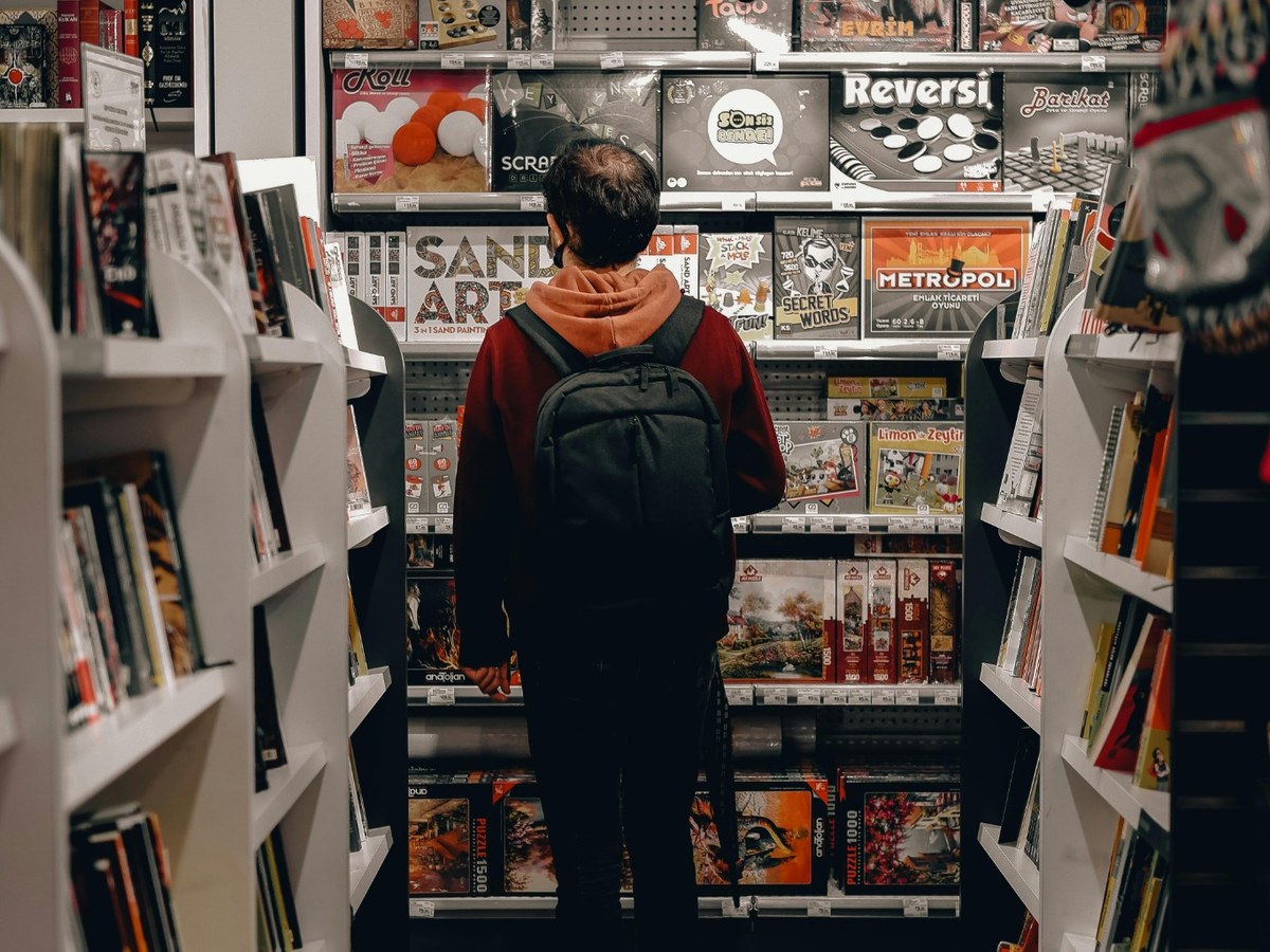 A customer browsing board games in a games retail environment