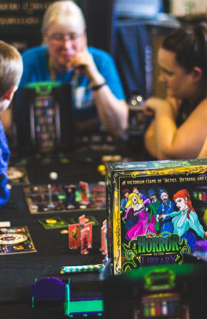 Players gathered around Horror in the Library at a live event